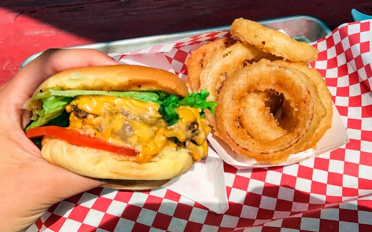 The Devil’s Tombstone Burger: two patties with the works and a special sauce, and a side of onion rings at Mama's Boy Burgers in the Great Northern Catskills. | Photo by Lauren Sandford