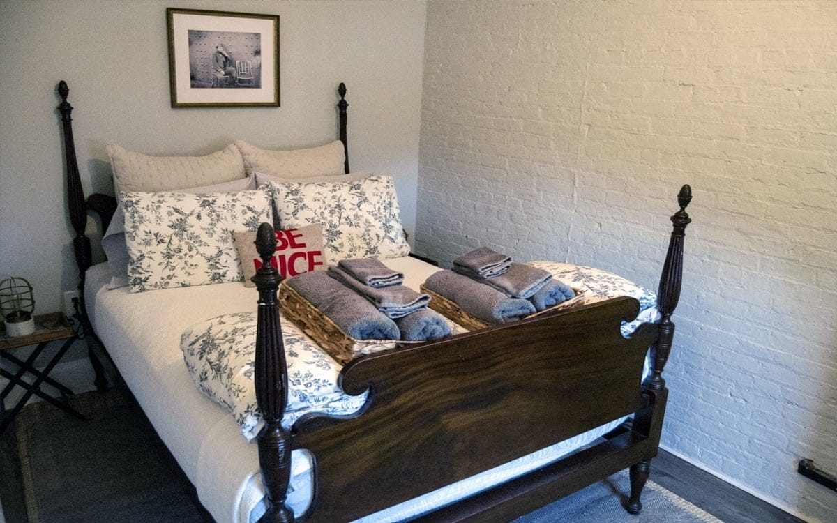 The Pennington's cozy corner room with a double bed, located on the second floor at Wm. Farmer & Sons. | Photo by Andrew Frey