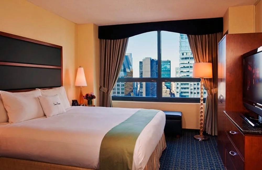 One of DoubleTree Suites Times Square's spacious bedrooms with a beautiful view. | Photo from DoubleTree Suites by Hilton: New York City - Times Square