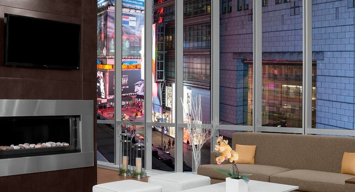 A comfortable lounge with a beautiful view of Times Square below. | Photo from Hilton Garden Inn Times Square Central