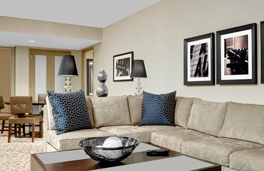 A living room setting in one of Hilton Times Square's spacious guest rooms. | Photo from Hilton Times Square