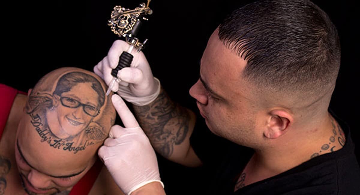 A Skilled Artist Takes on a Head Tattoo at the Saratoga Tattoo Expo. | Photo by Christine Neely