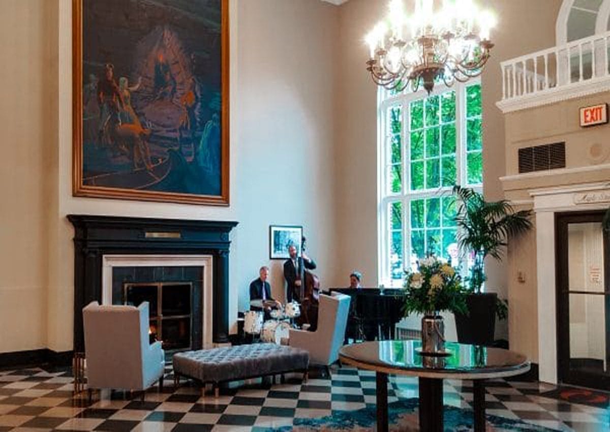 The elegant Queensbury Hotel of the Lake George Area. The lobby with charming black and white tiling and old-timey lounge, complete with mural and jazz band. | Photo by Salvatore Isola