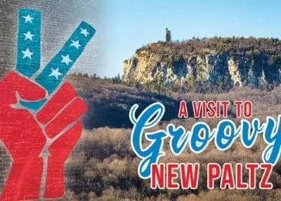 Vintage-style postcard featuring a red and blue peace sign, a rocky landscape with trees, and a distant cliff with a tower. The text reads, A Visit to Groovy New Paltz, capturing the spirit of adventure just like strolling the iconic Walkway Over the Hudson.