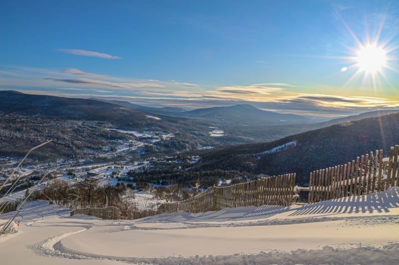 A breathtaking winter landscape of snowy mountains under a clear blue sky sets the perfect backdrop for a thrilling ski adventure. The sun shines brightly, casting long shadows over the snow-covered valley. A wooden fence runs along the snowy path, adding depth to this serene scene. A breathtaking winter landscape of snowy mountains under a clear blue sky sets the perfect backdrop for a thrilling ski adventure. The sun shines brightly, casting long shadows over the snow-covered valley. A wooden fence runs along the snowy path, adding depth to this serene scene.