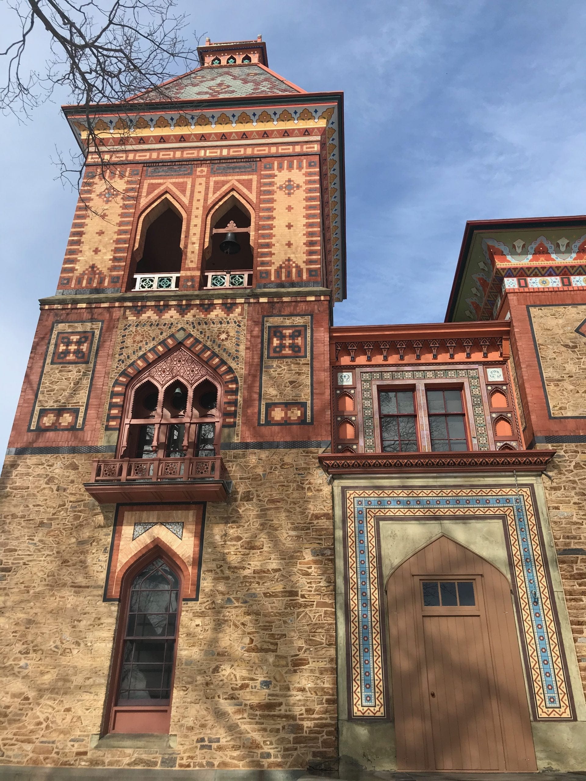 Visiting Hudsons Olana State Historic Site, you encounter a historical building with ornate Moorish-style architecture featuring intricate patterns and arches. Its facade boasts detailed brickwork and decorative trim, all under a clear blue sky. Visiting Hudsons Olana State Historic Site, you encounter a historical building with ornate Moorish-style architecture featuring intricate patterns and arches. Its facade boasts detailed brickwork and decorative trim, all under a clear blue sky.