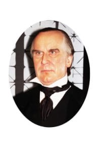 A person in formal attire, exhibiting a presidential air with a serious expression, stands against a backdrop of geometric patterns. A person in formal attire, exhibiting a presidential air with a serious expression, stands against a backdrop of geometric patterns.