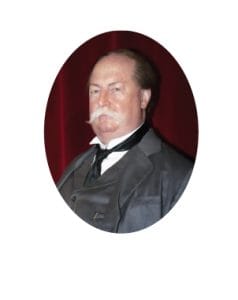 A man with a mustache in a formal suit, vest, and tie stands against a deep red background, exuding a presidential air. His attire suggests a historical or vintage style. A man with a mustache in a formal suit, vest, and tie stands against a deep red background, exuding a presidential air. His attire suggests a historical or vintage style.