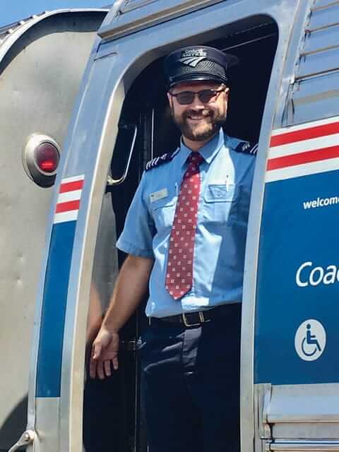 Amtrak conductor John Christman in train entrance