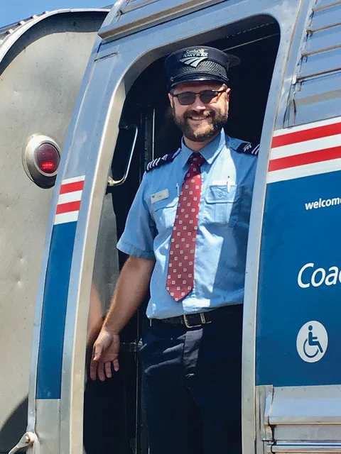 Amtrak conductor John Christman in train entrance