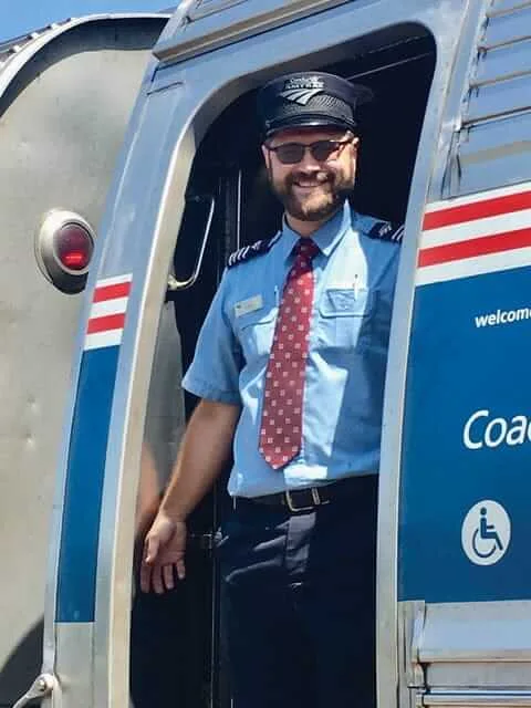 Amtrak conductor John Christman in train entrance