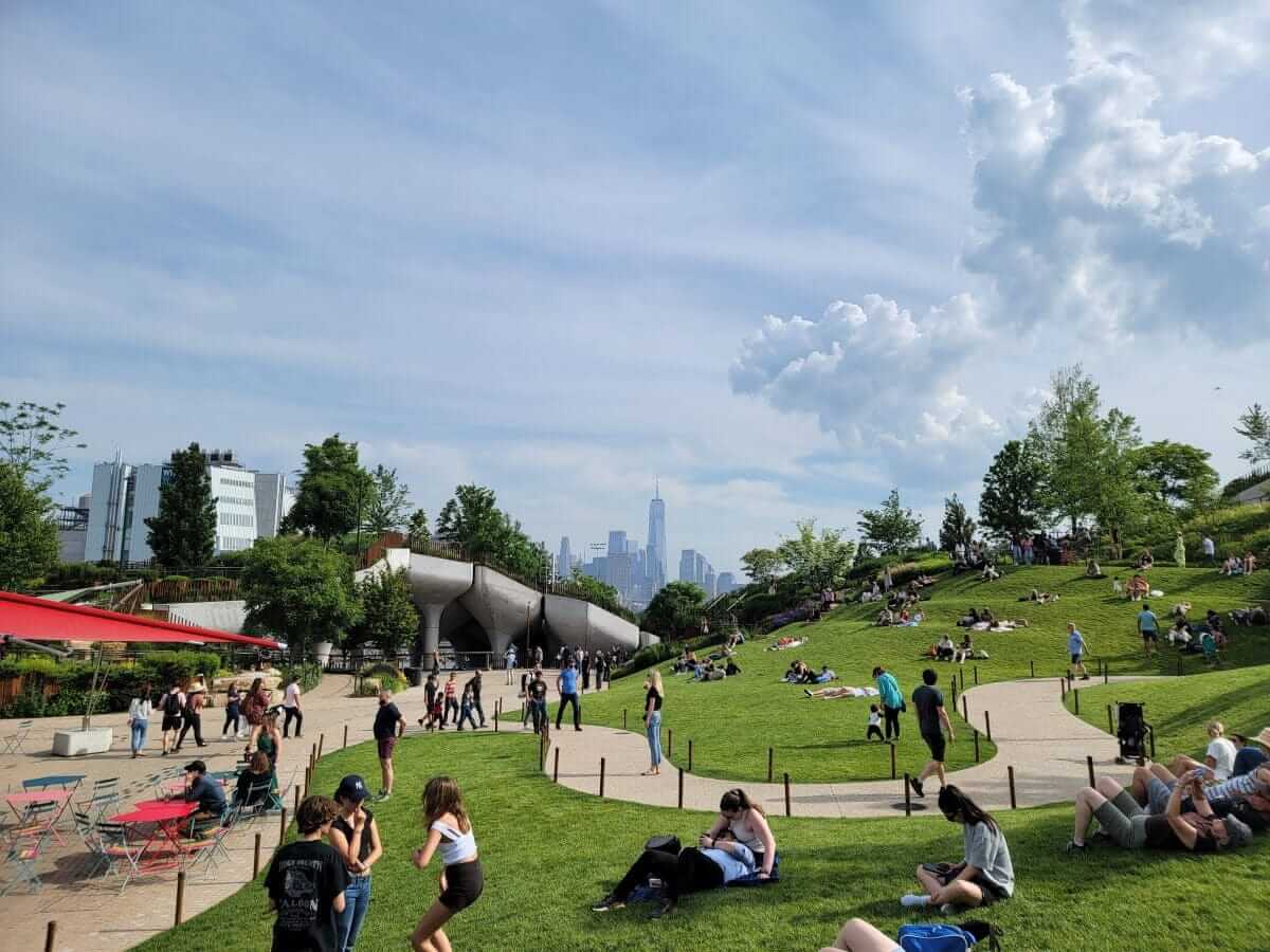 people lounging on grass at little island in nyc