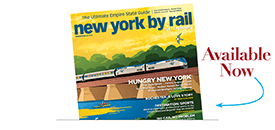 Cover of “New York By Rail” magazine featuring a train crossing a bridge over a river with trees in the background. Text reads “Available Now” with an arrow pointing to the magazine’s Header, styled using Elementor.