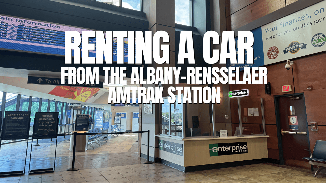 A car rental counter for Enterprise is located inside the Albany-Rensselaer train station, with seating, ticketing area, and informational signs in the background. Large white text about renting a car overlays the Amtrak station image.