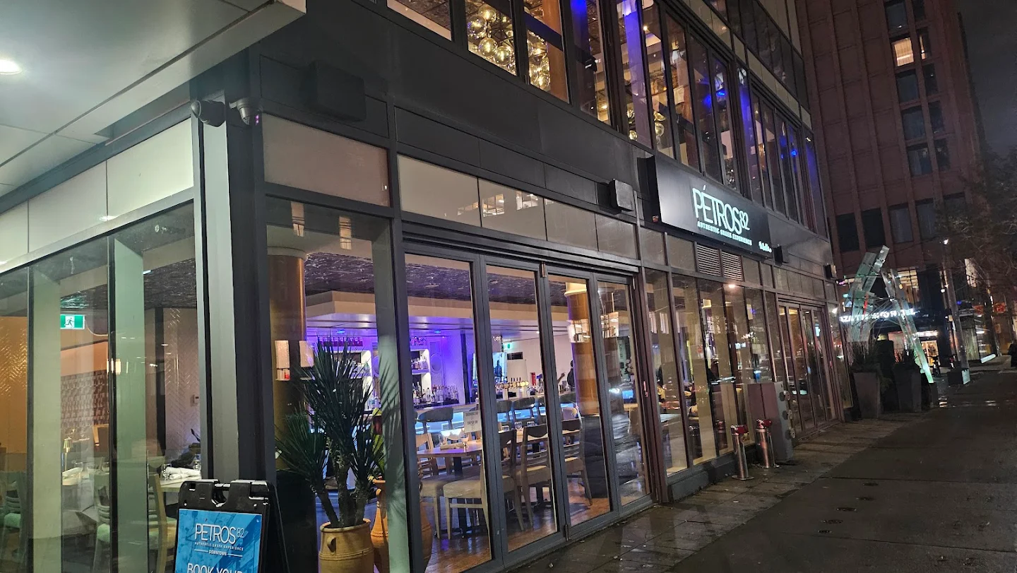 A building with glass windows, home to the inviting Petros82 Restaurant.